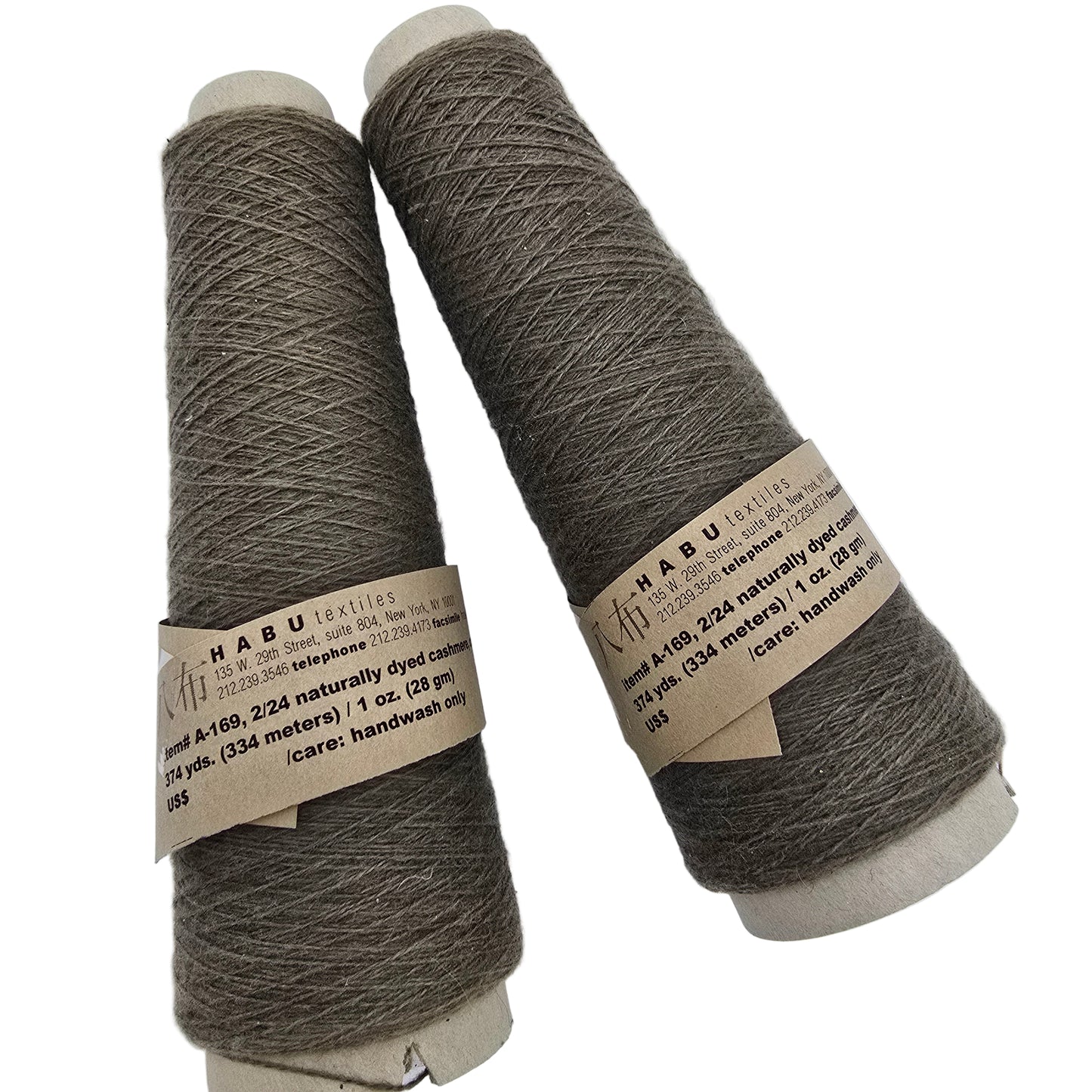 Two cone of Habu Textiles brown yarn with labels on a white background