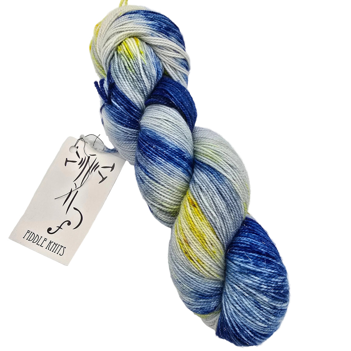 A skein of variegated yarn with blue, white, and yellow colorwork, featuring a paper tag that reads 'FIDDLE KNiTS' on a plain white background.
