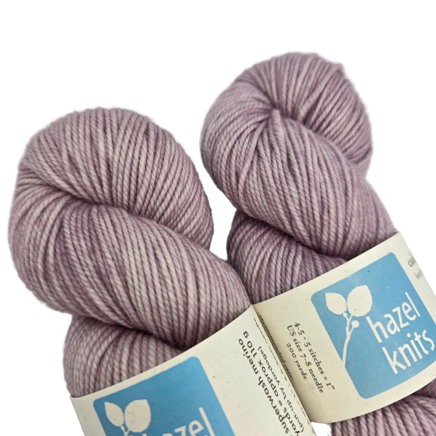Close-up image of Cadence_yarn by_Hazel_Knits_in the color Thistle with labels on a white background.