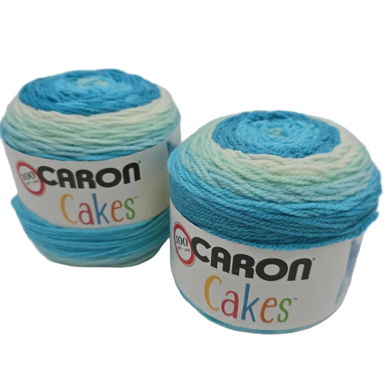 Image of two Caron Cakes of yarn in the color Faerie Cake with labels on a white background.