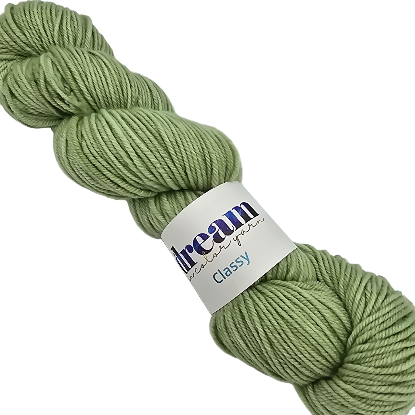Image of a single skein of Classy by Dream worsted wool merino yarn with label on a white background in a color called Sprout which is a solid light green.