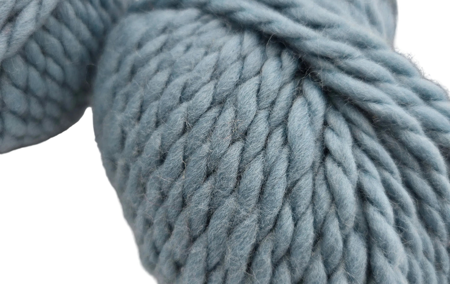 Close-up image of Baby by Tahki yarn in color 39 on a white background.