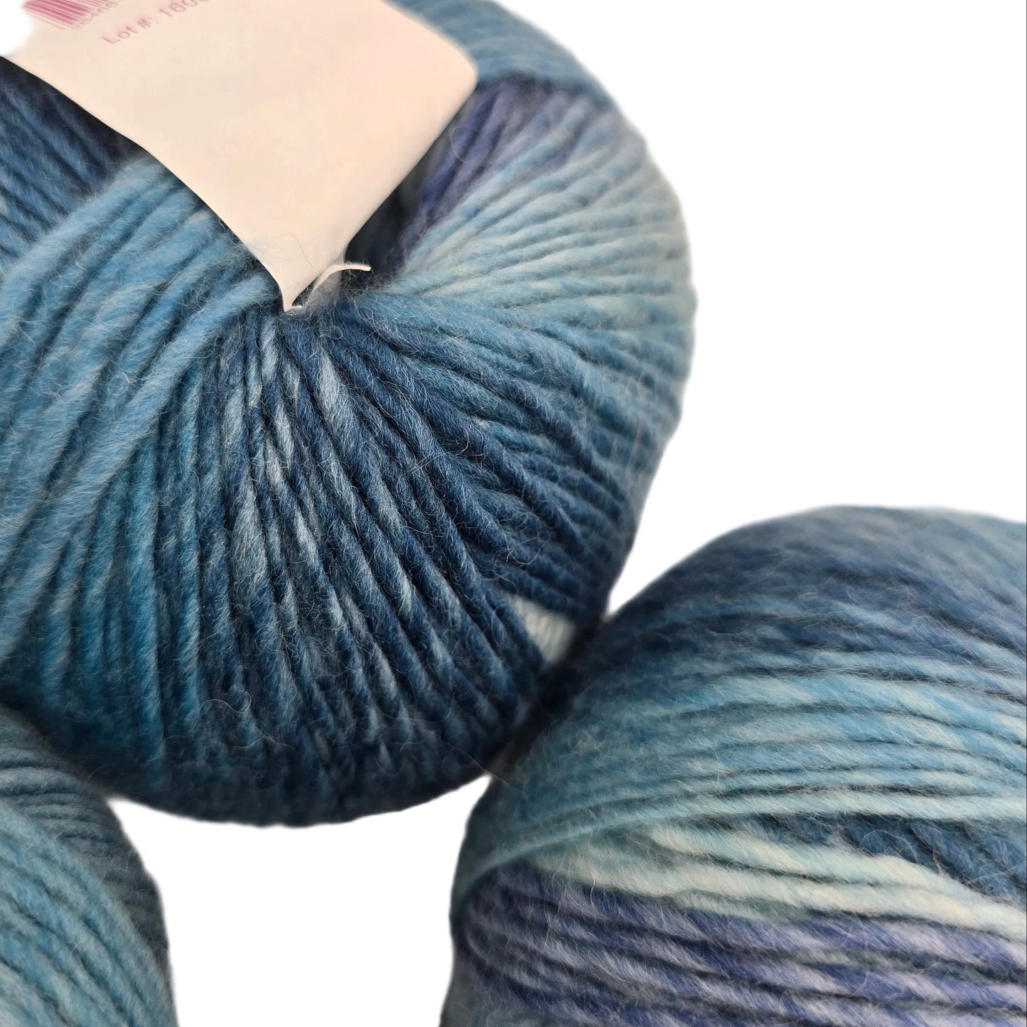 Close-up image of Chroma Worsted yarn by Knit Picks in the color Weather Vane with label on a white background.