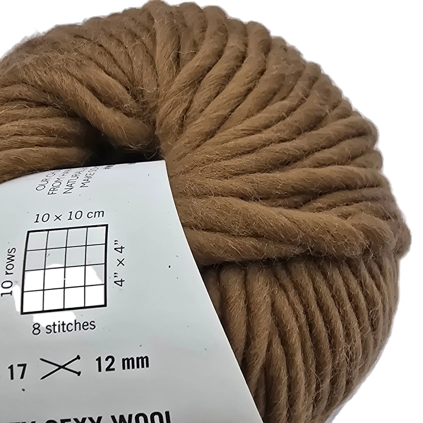 Close-up Image of a single ball of Crazy Sexy Wool Yarn by Wool And The Gang in the color Fawn Brown with label on a white background.