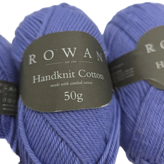 Close-up image of Handknit Cotton by Rowan yarn in color 353 Violet with label on a white background.