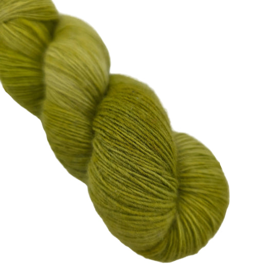 Close-up image of Lace by Malabrigo yarn in color 37 Lettuce on a white background.