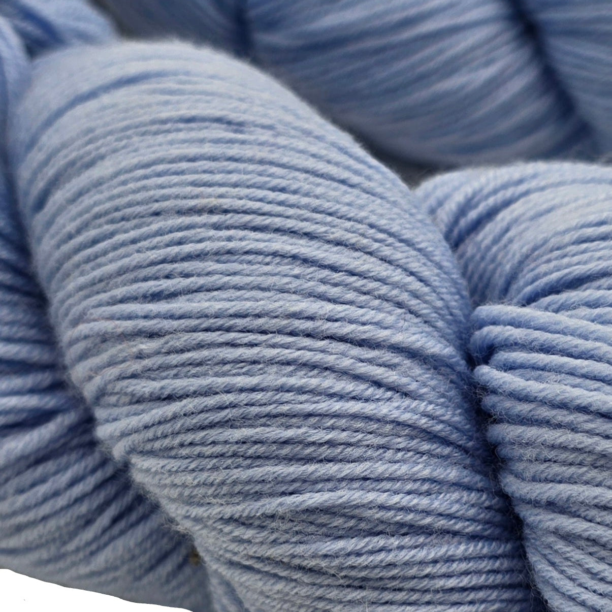 Close-up image of Super_Sock_by_Knitologie Yarn in the color_Gibbous_Moon on a white background.