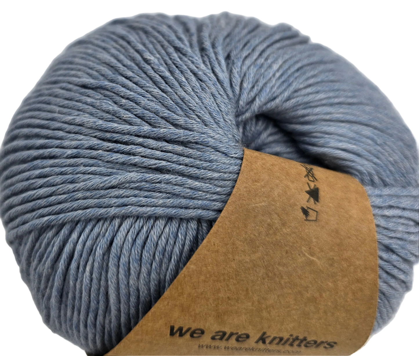 Close up image of a ball of The Cotton yarn by We Are Knitters in the color Denim with partial label on a white background.