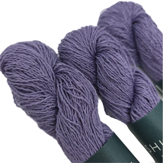 Close-up image of Twig by Shibui Knits- yarn in Majesty Color 2219 with partial labels on a white background.