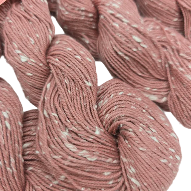 Close-up image of Willow Tweed yarn by Louisa in Color 16 Flower on a whiye background.