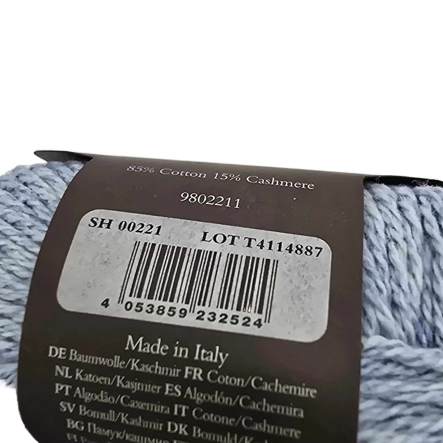 Close-up of backside of the label on a ball of Cotton Cashmere yarn by rowan in the color morning sky on a white background.