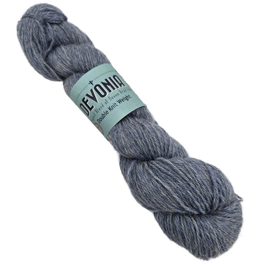 Image of a single skein on Devonia DK by John Arbon Textiles Yarn in the color snow ash with label on a white background.