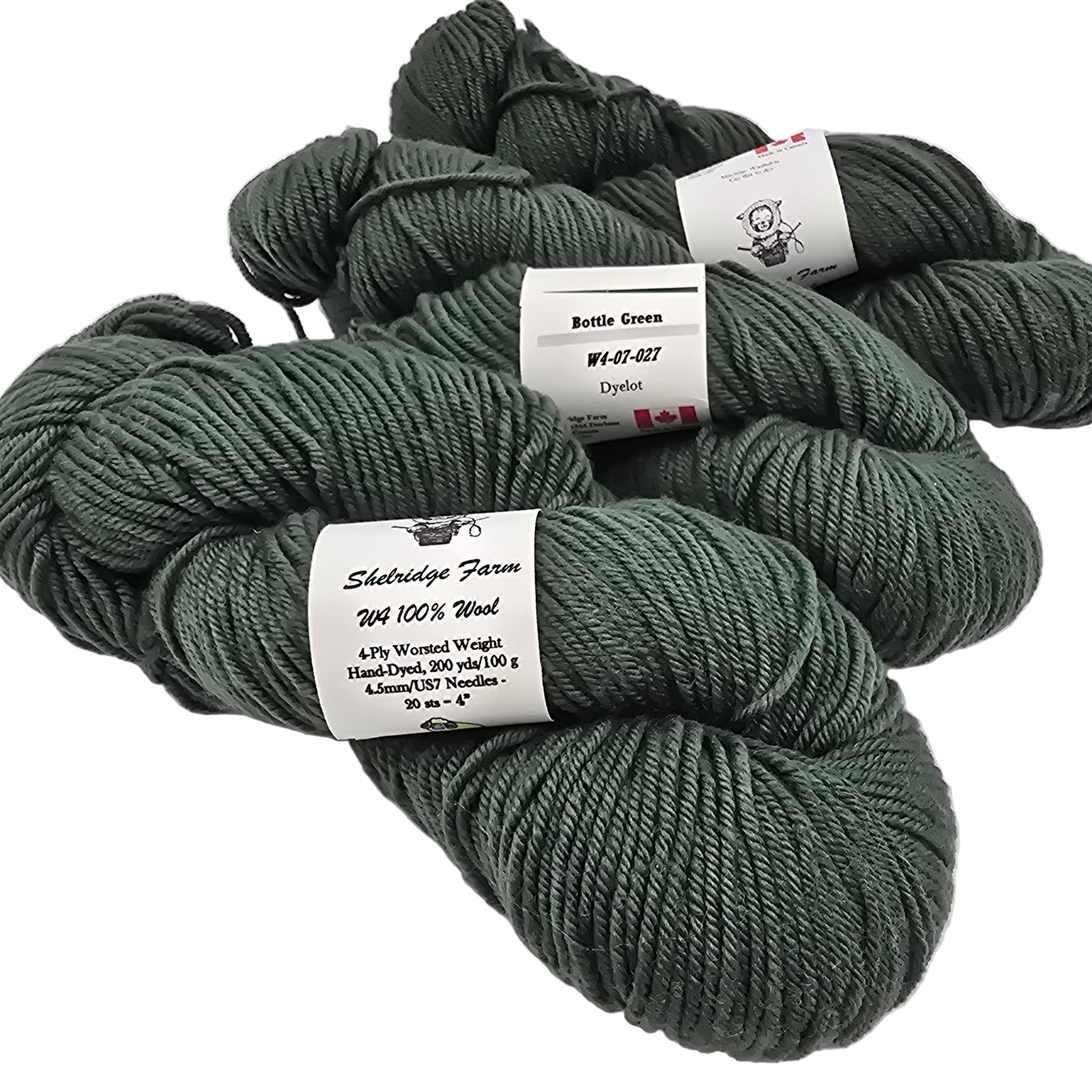 Image of 3 skeins of Shelrdige Farm W4 yarn in the color bottle green which is a dark forest green with labels on white background.