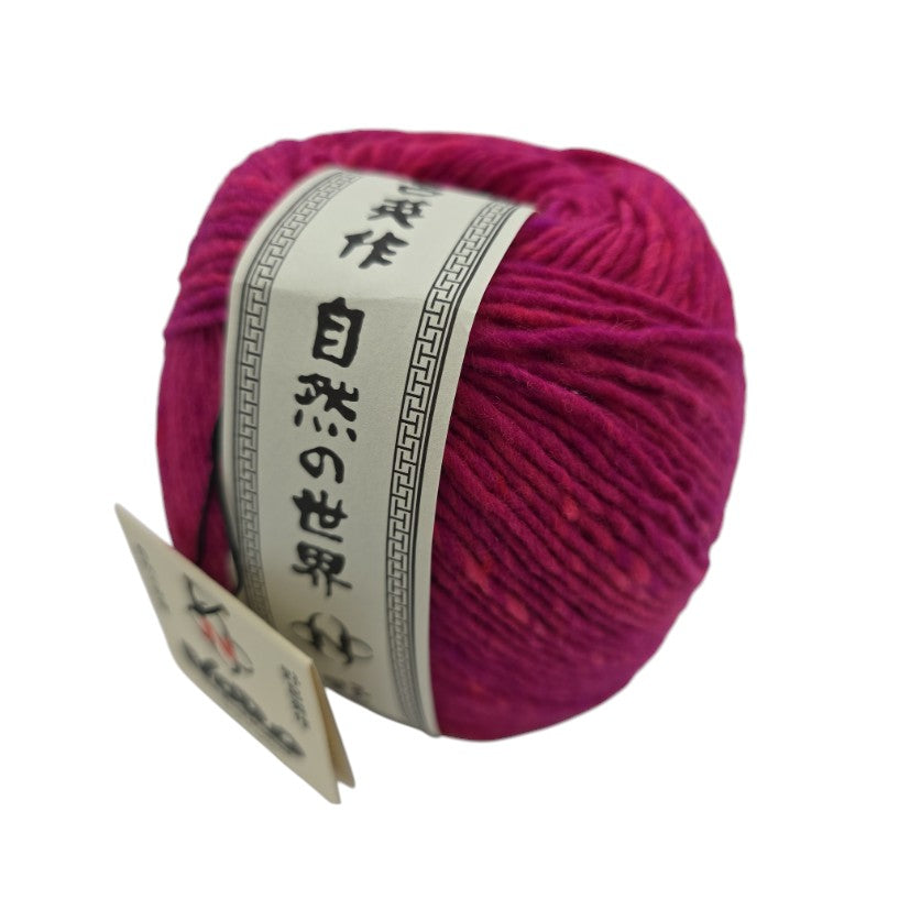 Ball of pink Malvinas by Noro yarn with a label on a white background