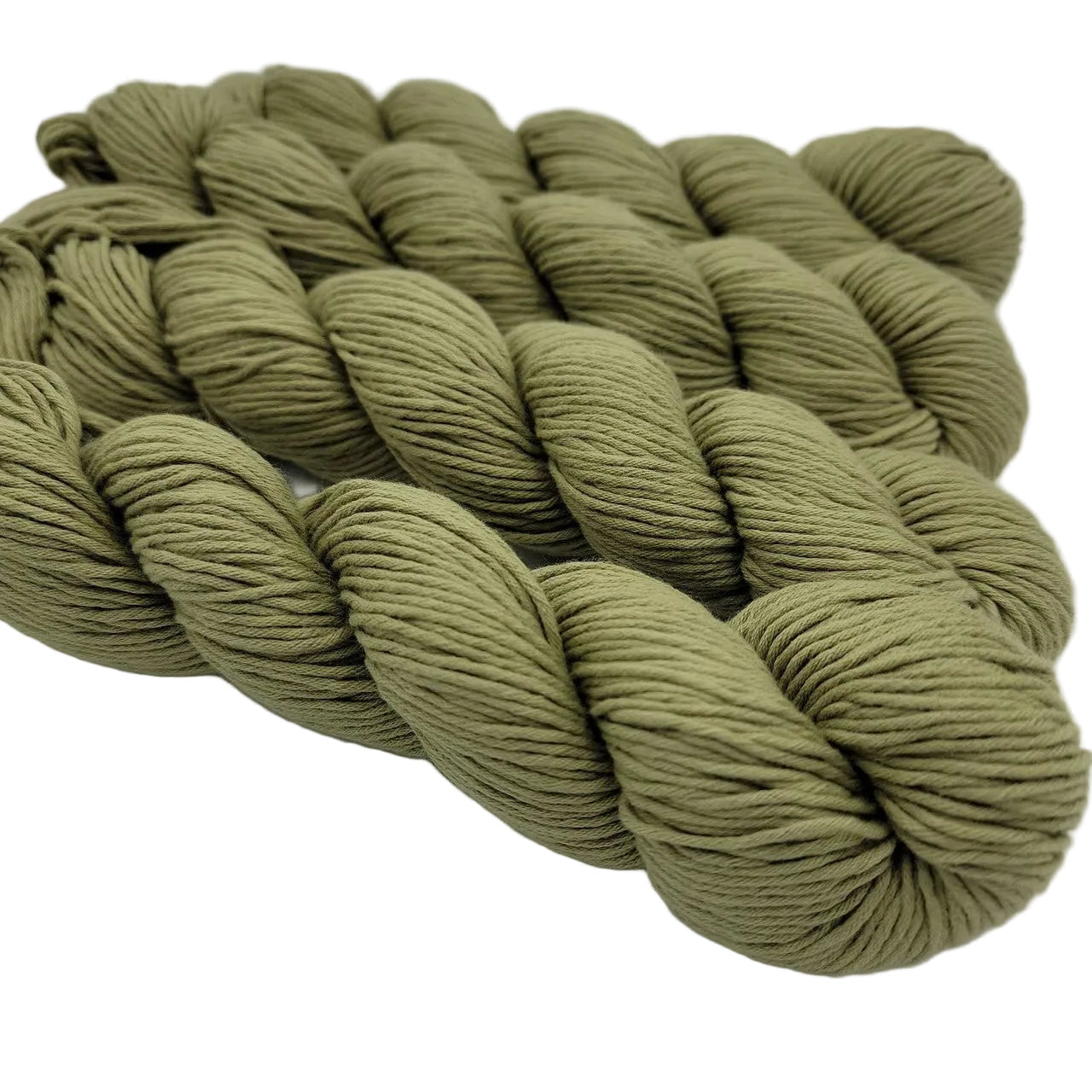 Image of 4 skeins of organic cotton skinny yarn by blue sky fibers in color number 312 pear on a white background.