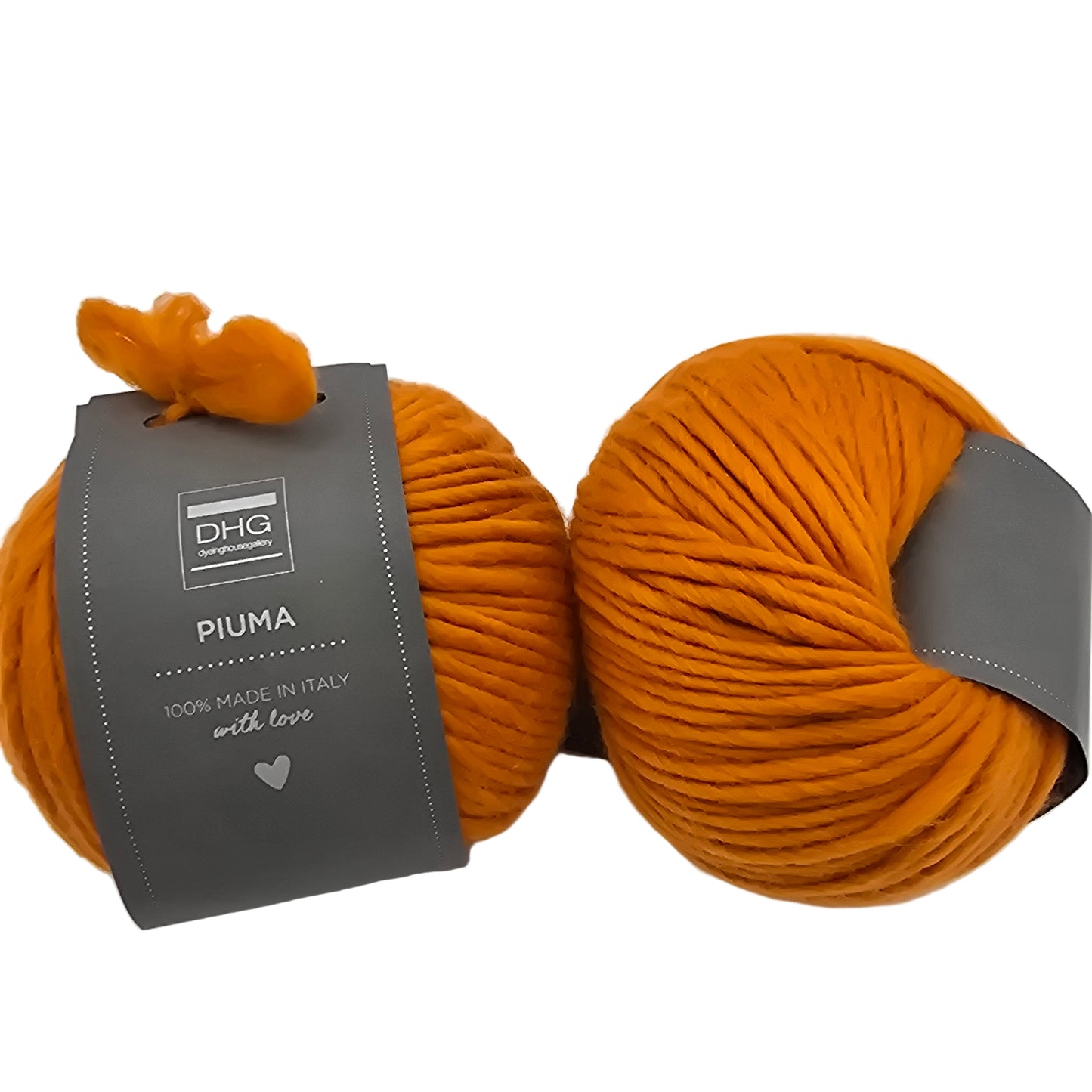 Image of two balls of Piuma by DHG Ultra Soft bulky Italian Merino Wool yarn in the color pumpkin which is a solid orange with labels on a white background