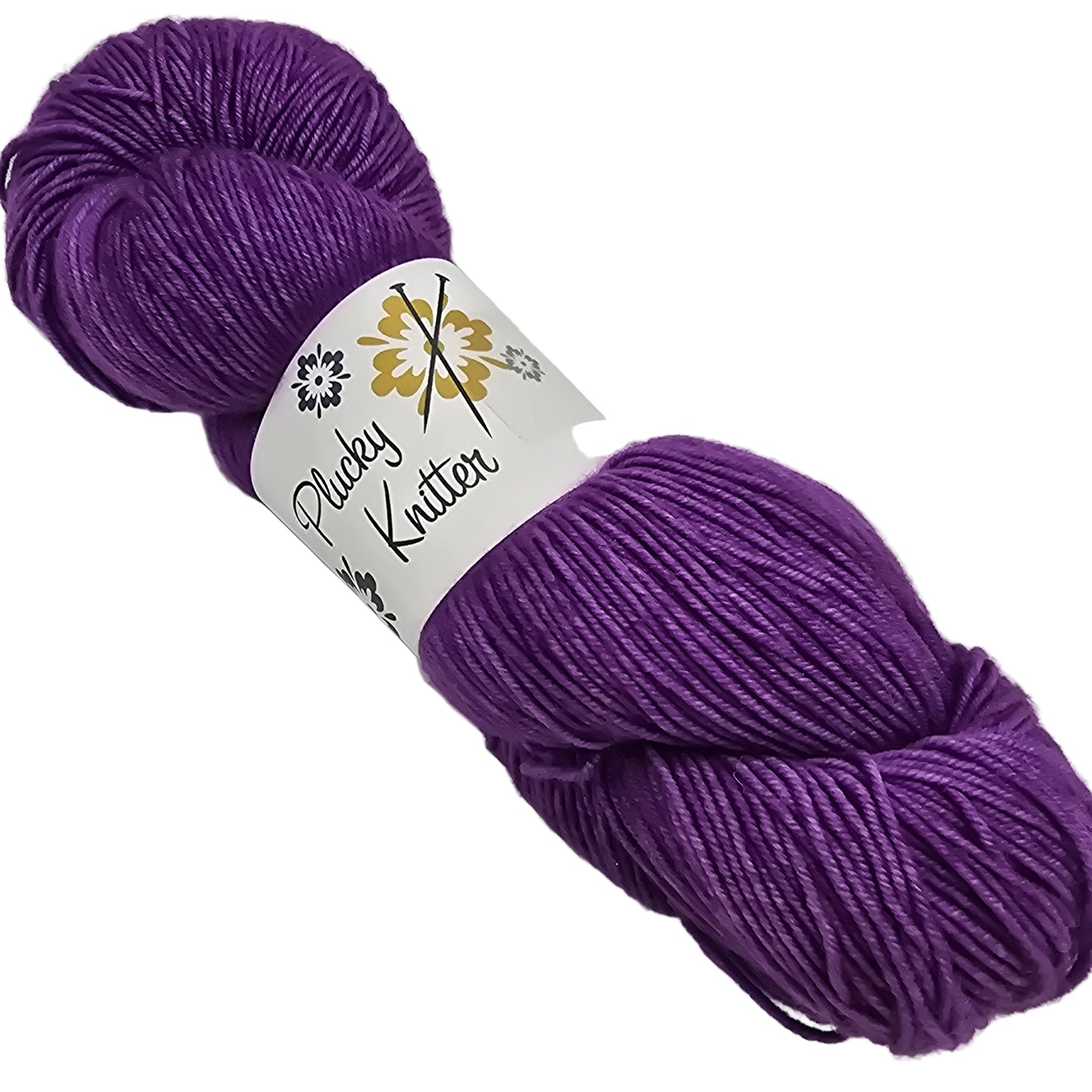 Image of a single skein of Plucky Knitter Merino, Cashmere, Nylon blend yarn in the color Eat Cake which is a deep purple with label on a white background.