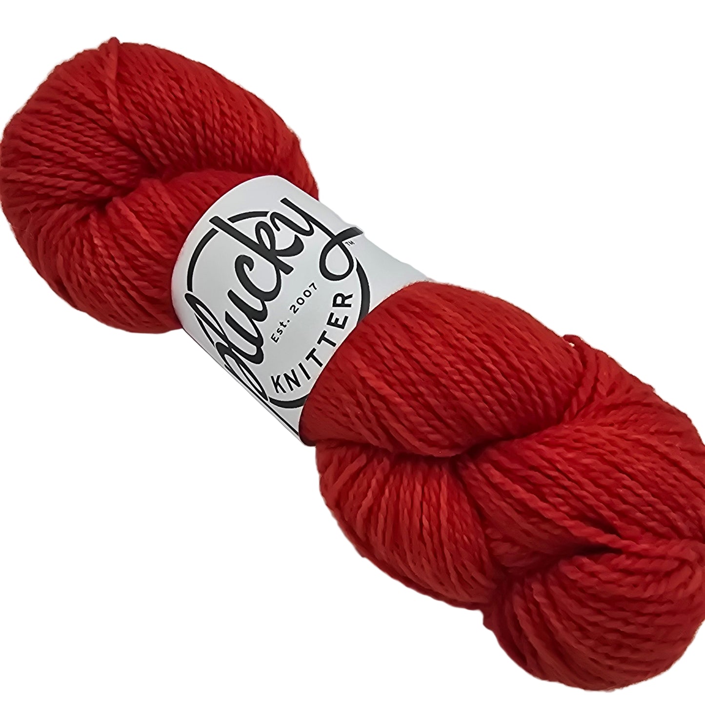 Image of a single skein of Plucky Knitter Merino- Cashmere blend yarn in the color henley which is a red.