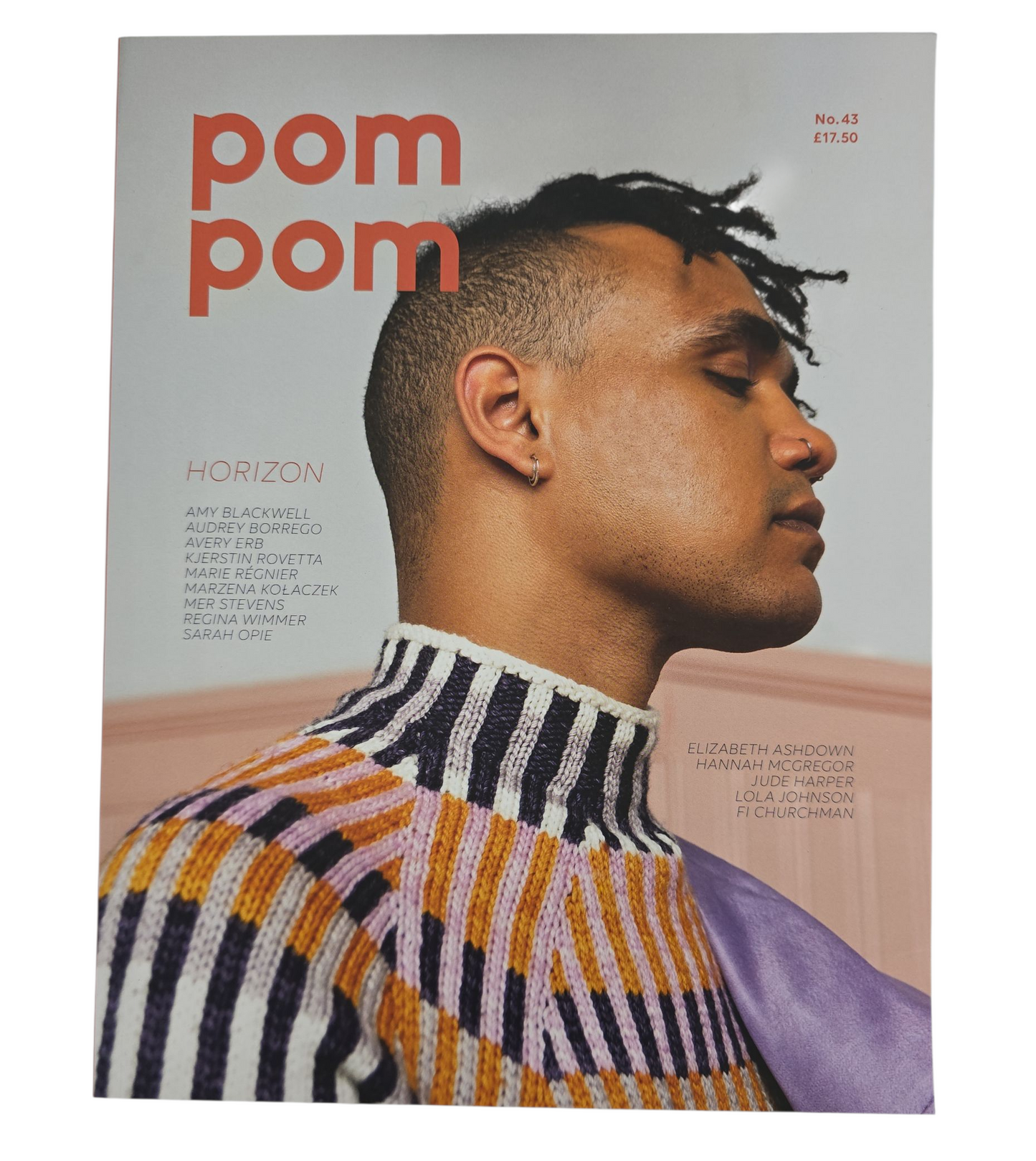 Magazine cover with a man wearing a patterned sweater, featuring the brand 'pom pom'. on white background