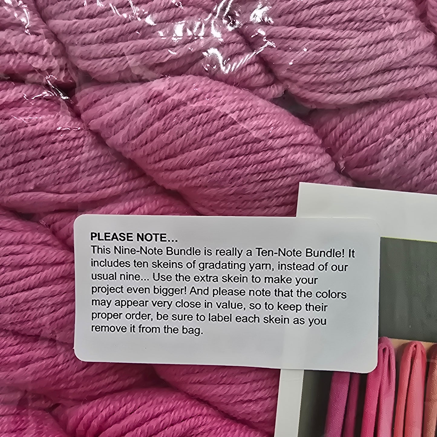 Close-up image of label on Nine-Note Bundle of Purl Soho Yarn in the color Dragon Fruit which is a pink gradient.