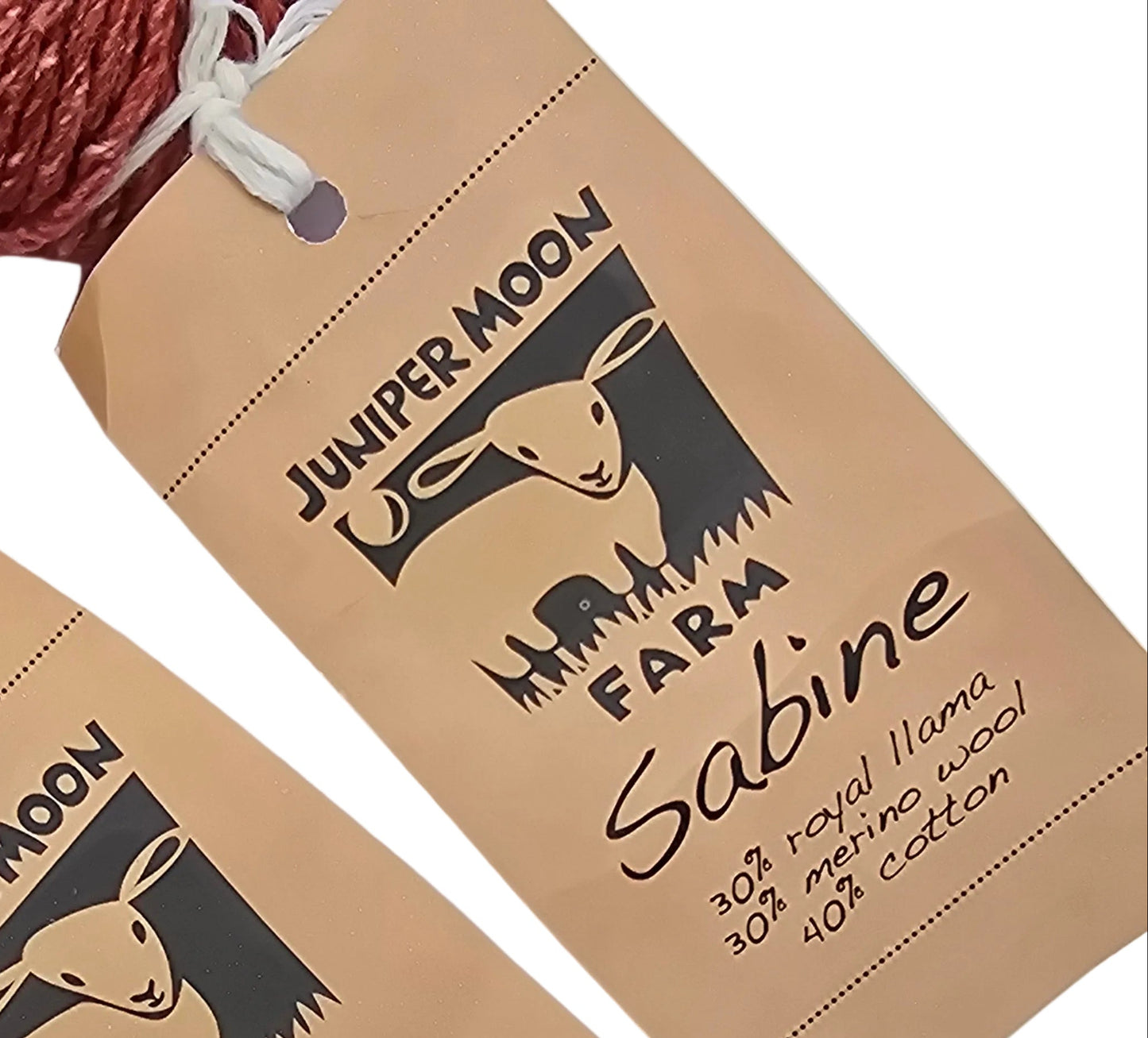 Two skeins of yarn with 'Juniper Moon' labels on a light blue background