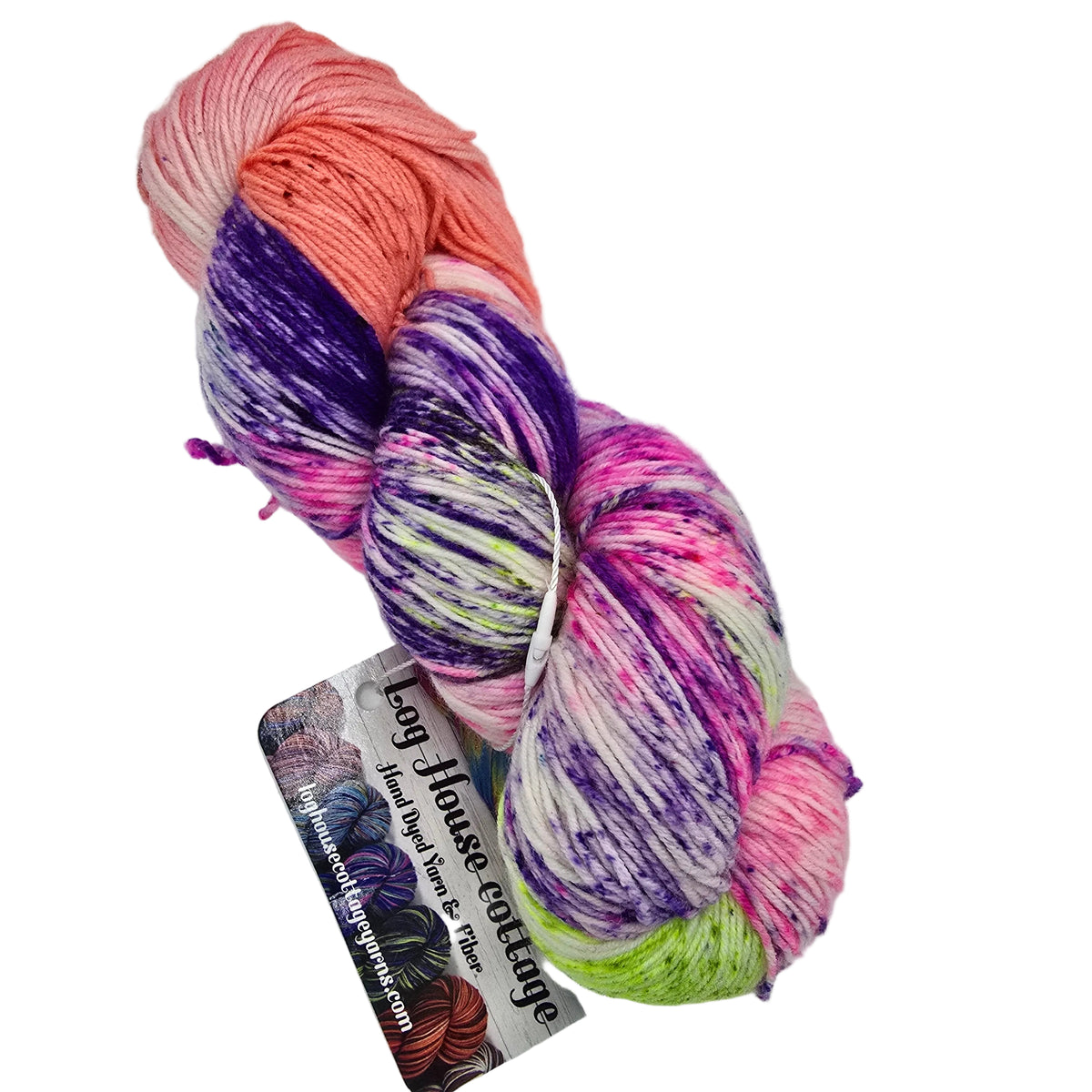A single skein of variegated yarn with peach, purple, pink, white, and lime green sections, attached to a paper tag that reads 'Log House Cottage'. The yarn is photographed on a plain white background.