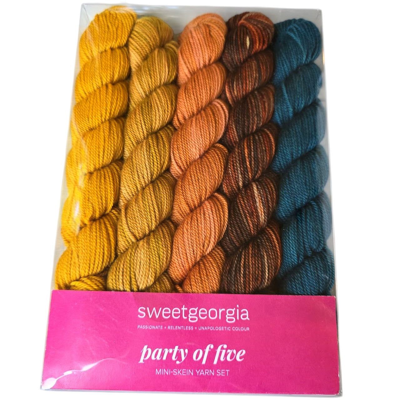 Image of a Sweetgeorgia brand pack of 5 different colored mini skeins of yarn. Colors include 2 yellows, 2 oranges, and a blue skein. Color is called farm to table by manufacturer, in a pink and white package on a white background.