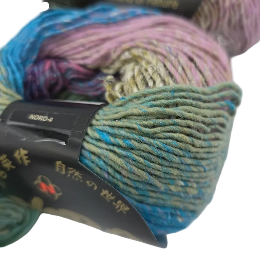 Close-up image of Aya Yarn by Noroin Color 2 with partial label on white background.