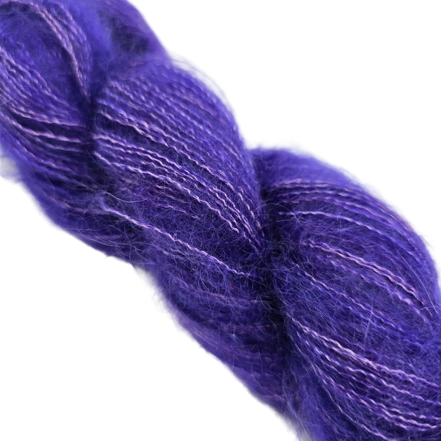Close-up Image of a single skien of Isle of Skye by Jorstad in the color Violet Femmes 0920 on a white background.