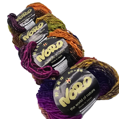 Image of 4 skeins of kureyon by noro woll yarn in color 138 with labels on a white background.