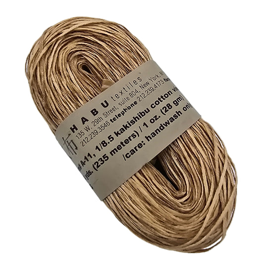 Image of a single hank of A-11 Kakishibu Cotton Viscose by Habu Textiles in Color 21 with label on a white background.