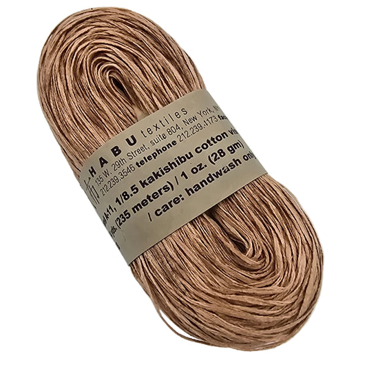 Image of a single hank of A-11 Kakishibu Cotton Viscose by Habu Textiles in Color 22 with label on a white background.