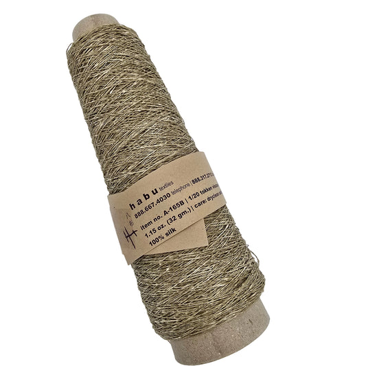 A spool of Habu brand yarn wound on a cardboard cone, with a paper label wrapped around the middle, shown against a plain white background.