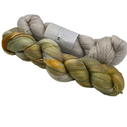 Image of two skeins of Alpaca Silk DK Yarn by Expression Fiber Arts on a white background.