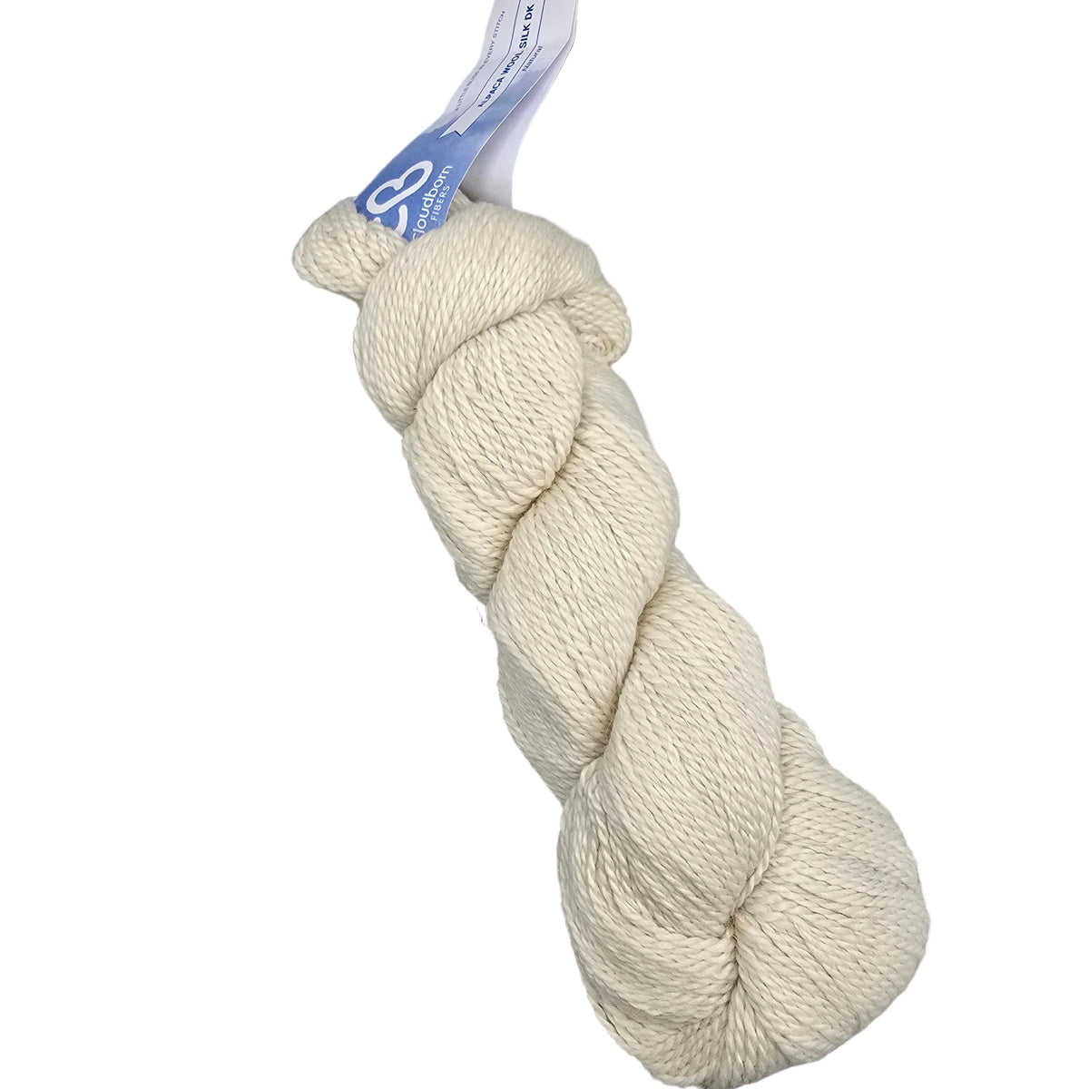 A skein of cream-colored yarn with a blue and white paper label, photographed on a neutral gray background.