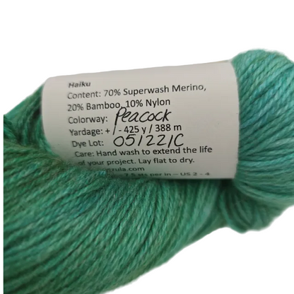 Turquoise yarn with a label on a white background