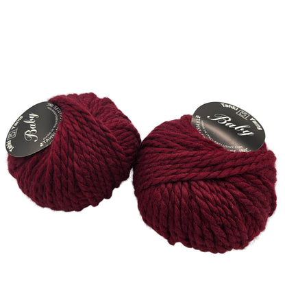 Image of two balls of Baby by Tahki yarn in color 32 with labels on a white background.