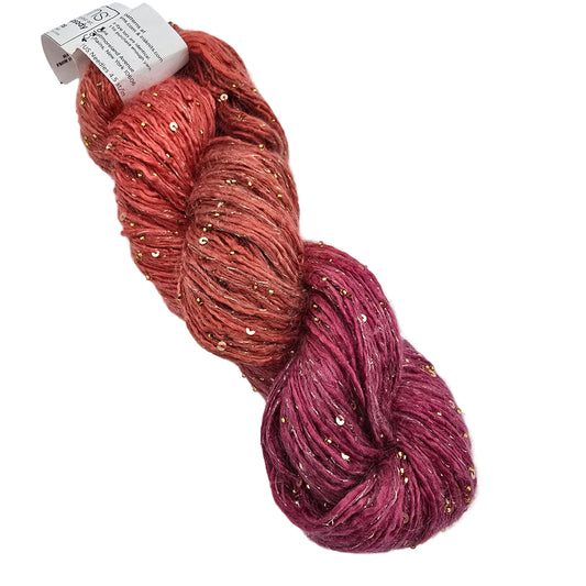 A skein of Beaded_Rhapsody_Sequins_Yarn_by_ArtYarns_in Color_115_Gold a variegated yarn with gold sequins, transitioning in color from a warm coral-orange at the top to a deep magenta-pink at the bottom, on a white background.