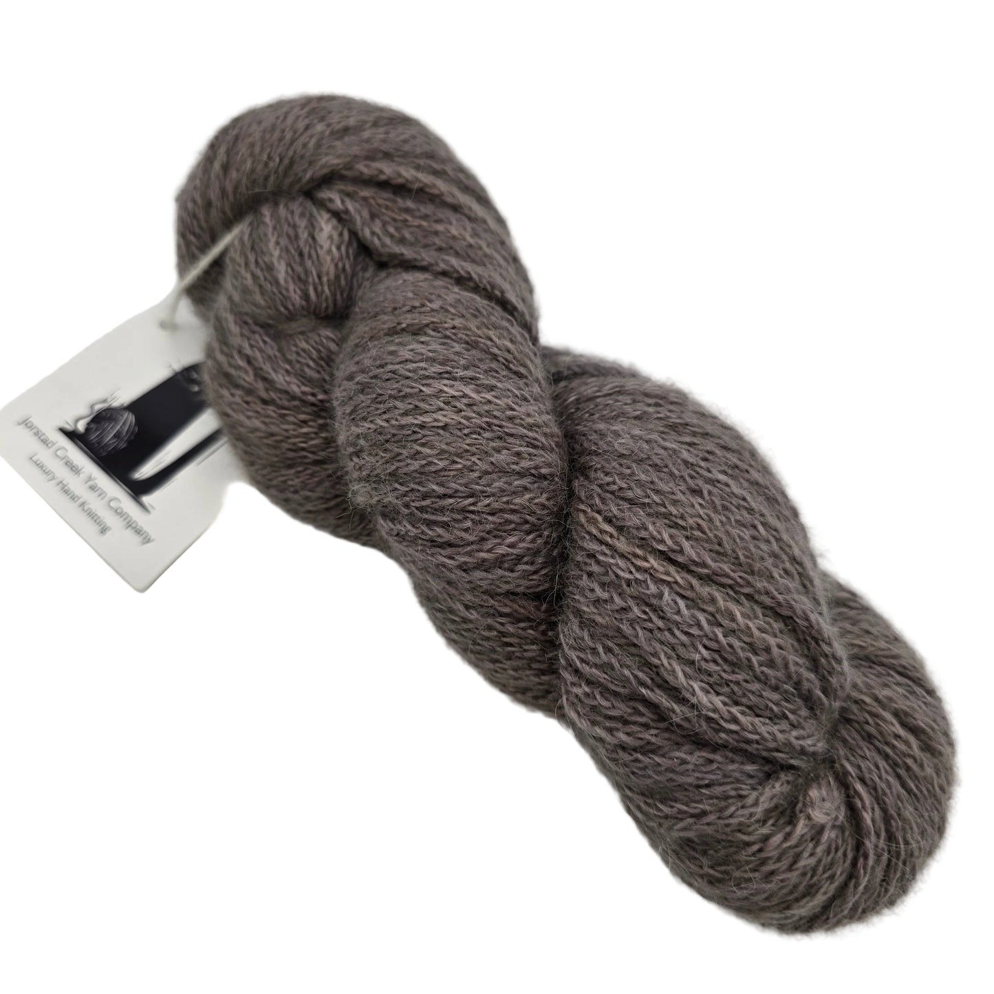 Image of a single skein of Belfair Yarn by Jorstad Creek in the color Caribou on a white background.