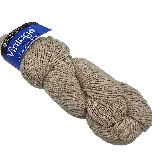 Image of a single skein of  Beige Vintage by Berroco Yarn in coloe 5104 with label on a white background.