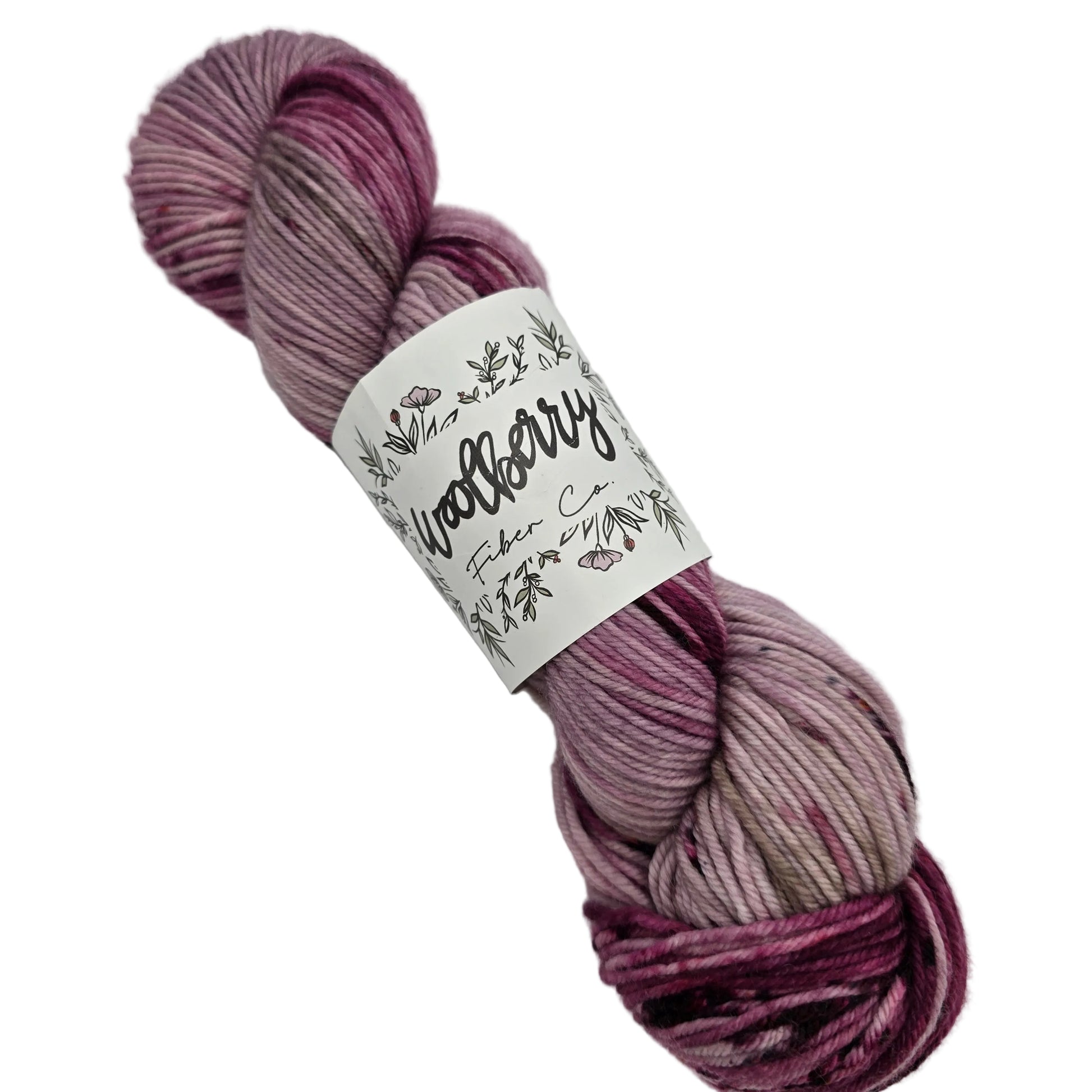 Image of a single skein of Berry DK yarn by Woolberry in the color Galentines Day with label on a white background.