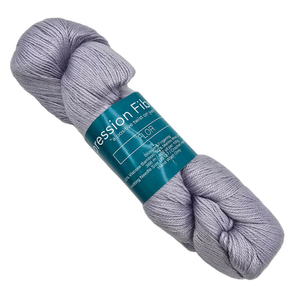 Image of a single skein of Blossom_Fingering_by_Expression_Fiber_Arts yarn in the color Showy with label  on a white background.