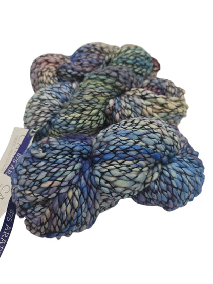 Multicolored Skeins of Caracol by Malabrigo Bulky Merino Wool yarn with a label on a white background