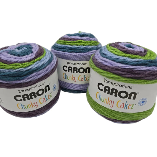 Image of three cakes of Caron Chunky Cakes yarn in the color Galaxy Macarons with labels on a white background.