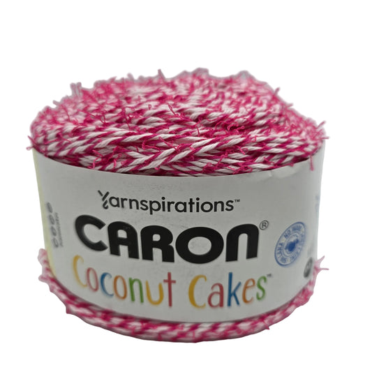 Image of a single  cake of Caron Coconut Cakes yarn in the color Fuchsia with label on a white background.