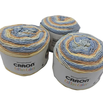 Image of 3 cakes of Caron cCotton Cakes Yarn in the color Beach View with labels on a white background.