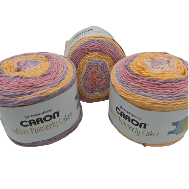 Image of three cakes of Caron Cotton Painterly Cakes Yarn in the color Fuchsia Fun with labels on a white background.