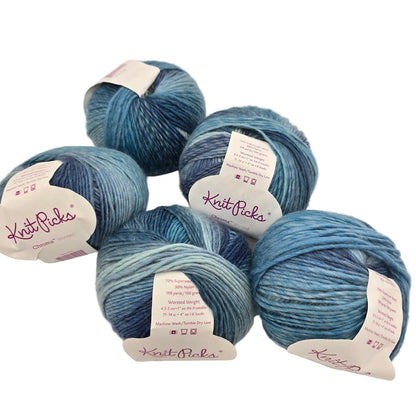 Image of 5 balls of Chroma Worsted by Knit Picks yarn in the color  Weather Vane with labels on a white background.