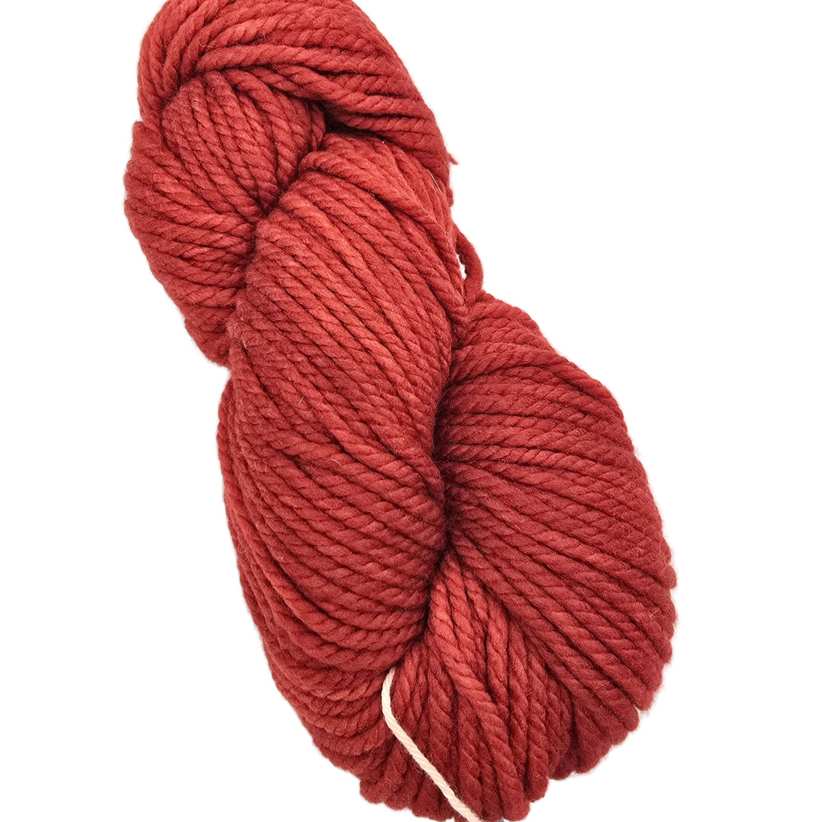 A skein of twisted cotton yarn in a warm rust red color, photographed on a clean white background.