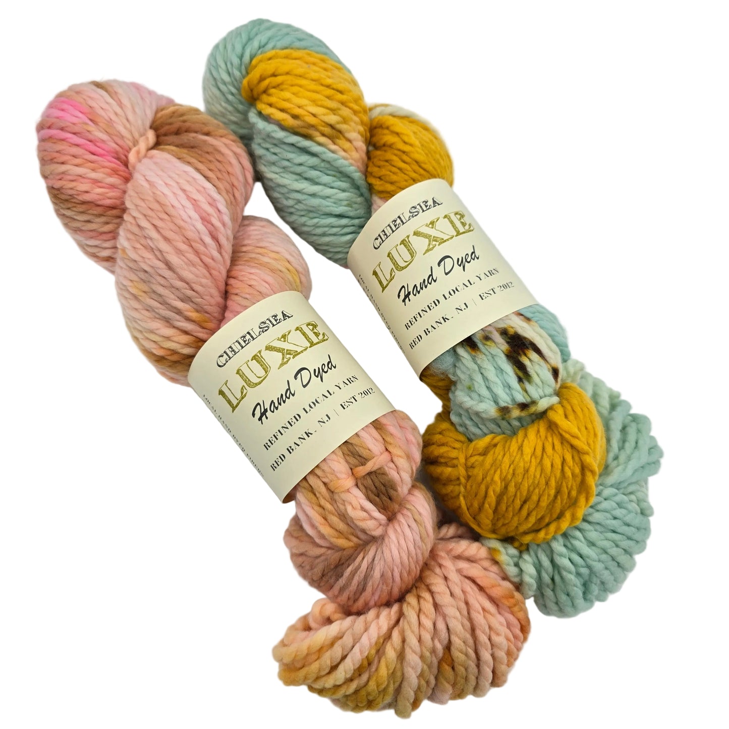 Image of two skeins of Chunky_yarn by_Chelsea_Luxe in various colors with labels on a white background.